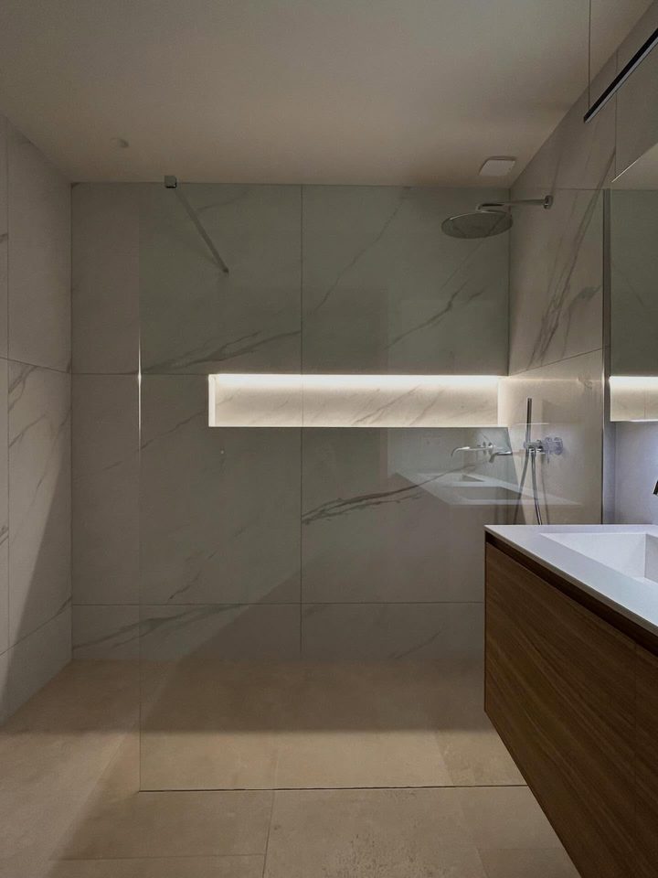 Douche à l'italienne terminée avec sa niche rétroéclairée et sa paroi vitrée